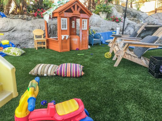 Artificial turf backyard with playhouse